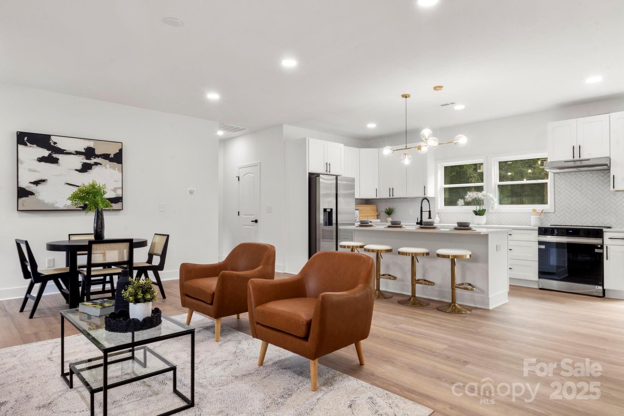 614 Hardin Road Dallas, NC 28034 - Photo 7 of 37 a view of kitchen with refrigerator stove dining table and chairs