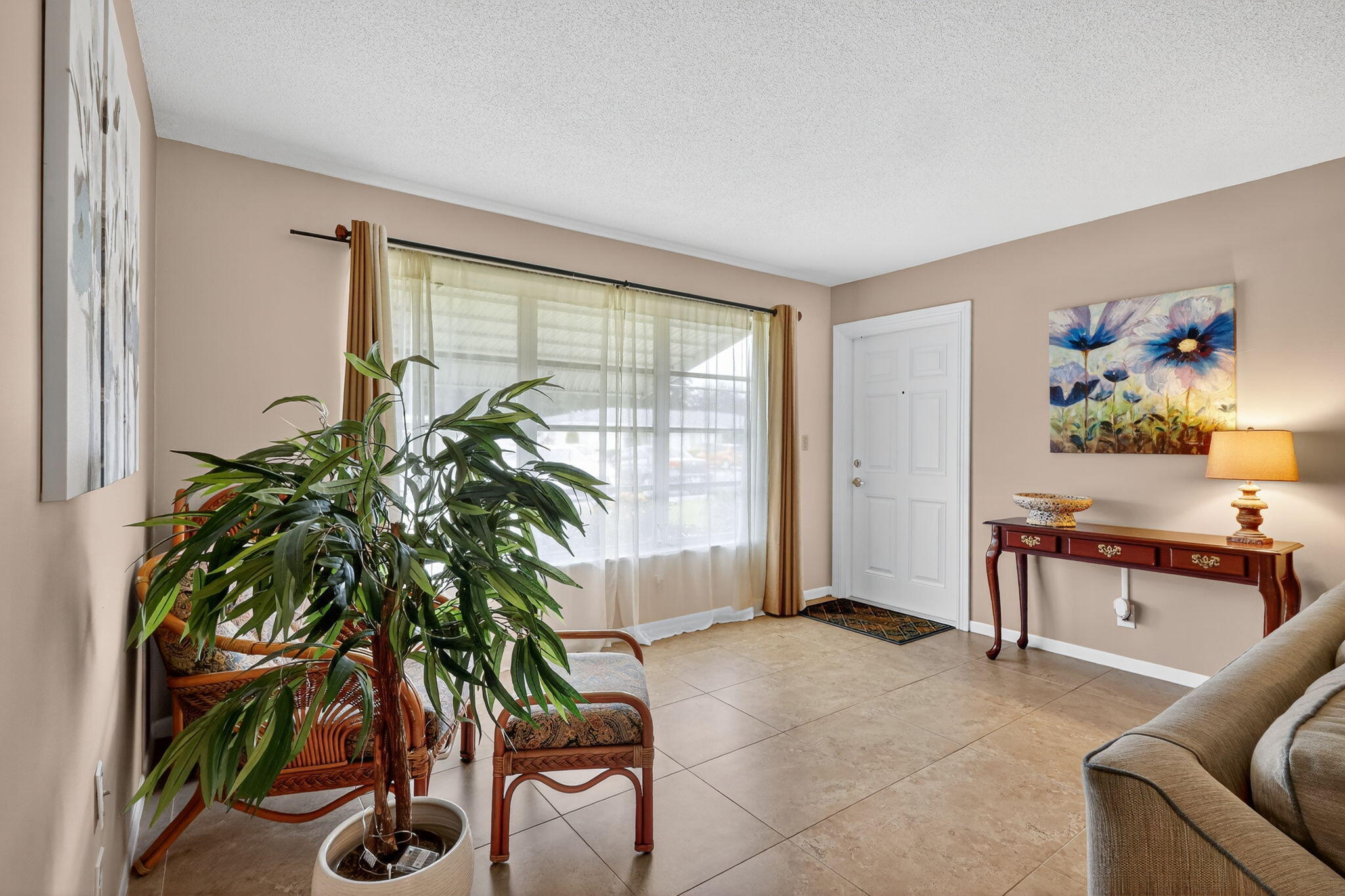 242 West High Point Court, Unit B Delray Beach, FL 33445 - Photo 11 of 36 a living room with furniture and a potted plant