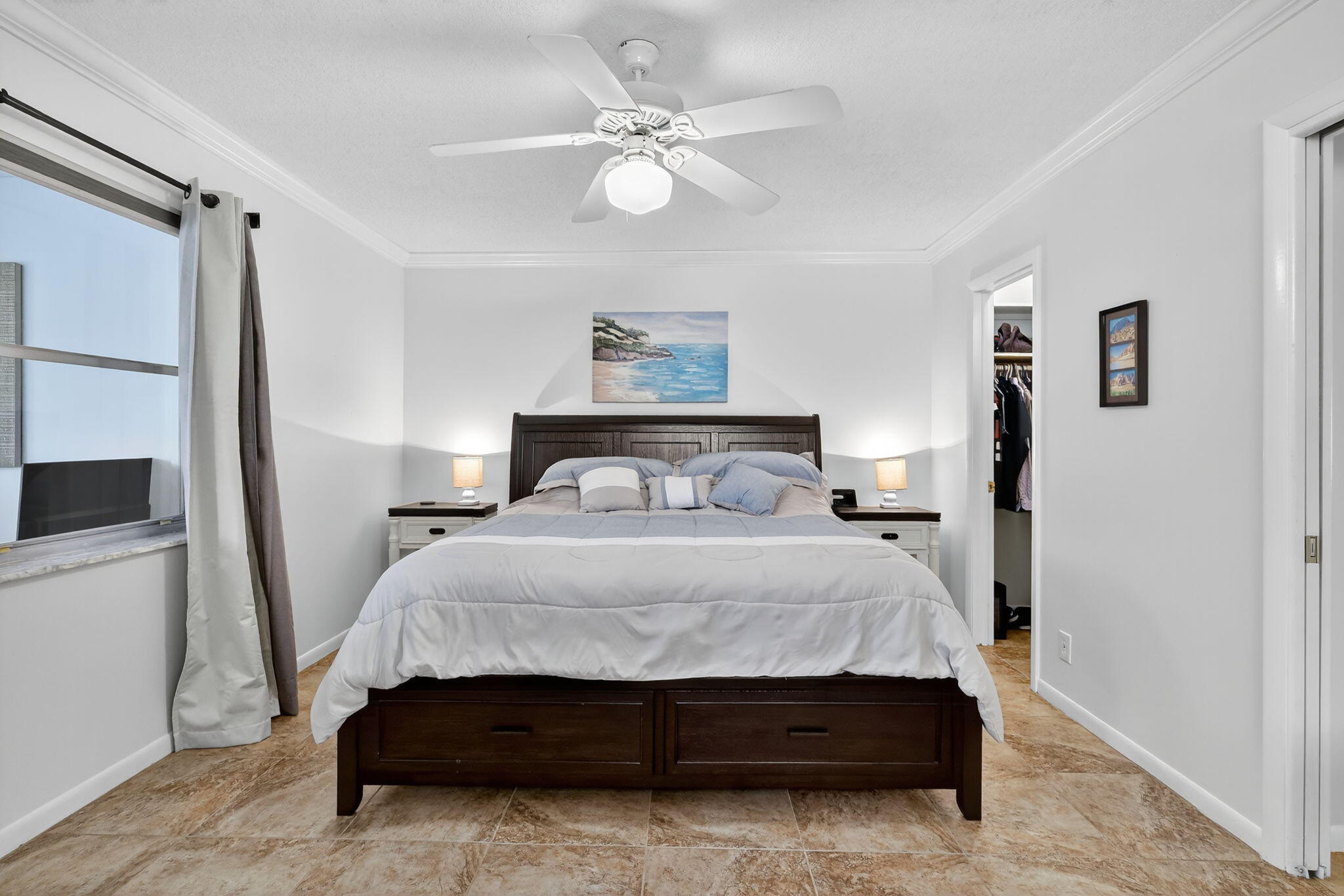 242 West High Point Court, Unit B Delray Beach, FL 33445 - Photo 17 of 36 a bedroom with a bed and a chandelier