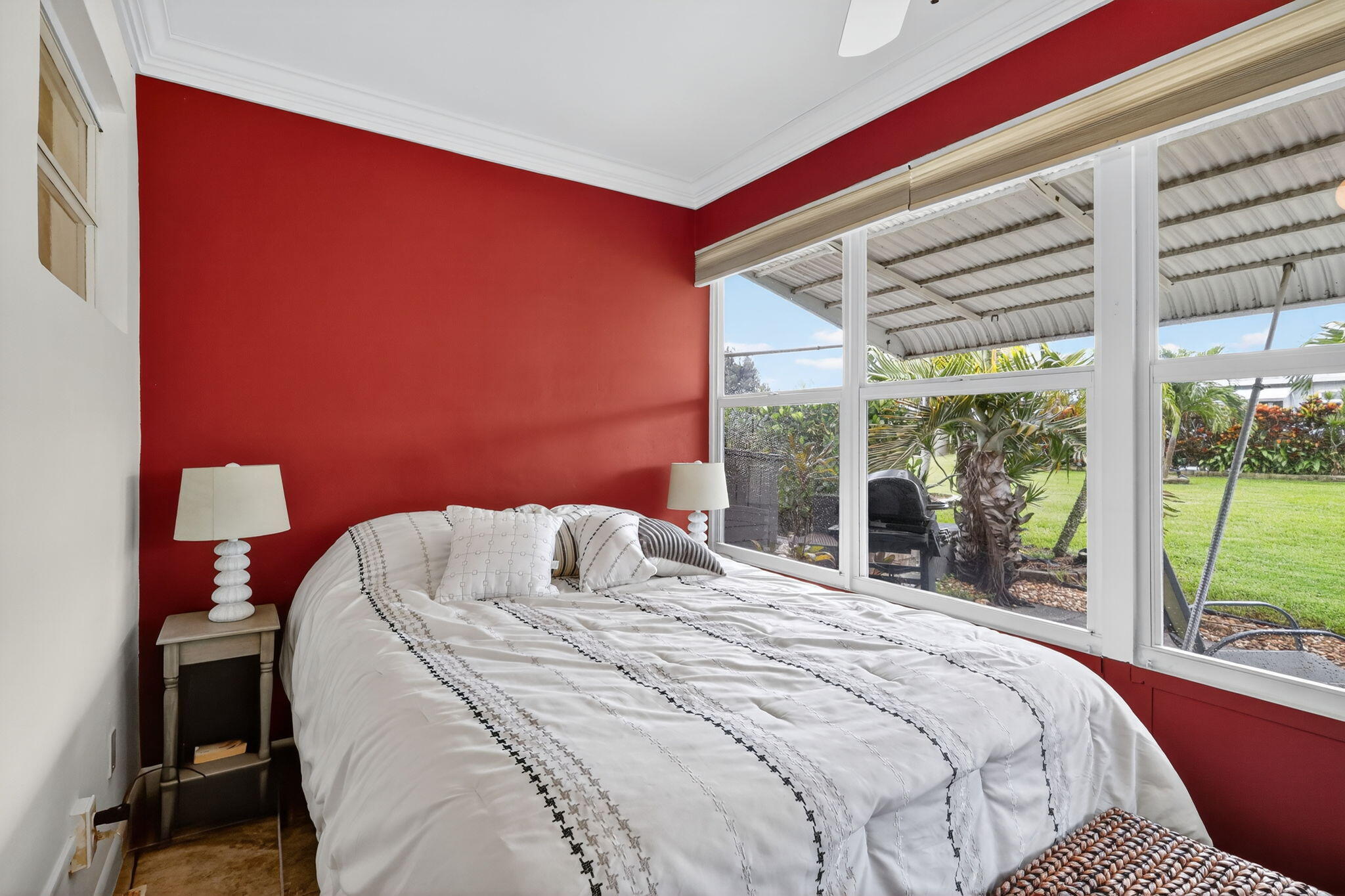 242 West High Point Court, Unit B Delray Beach, FL 33445 - Photo 23 of 36 a bedroom with a bed and a large window