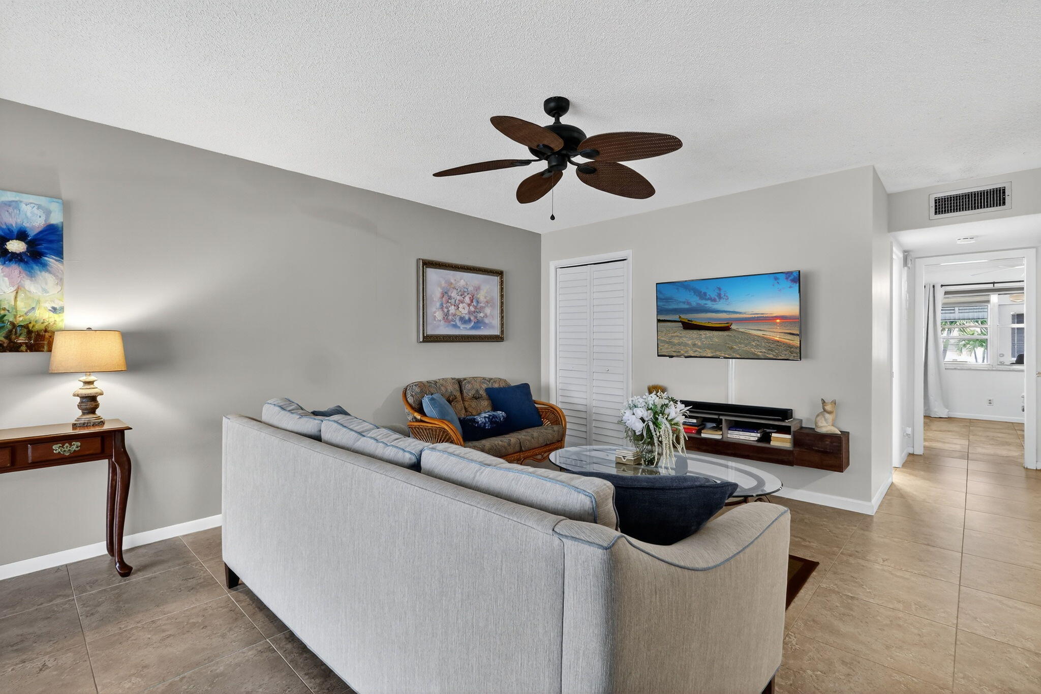 242 West High Point Court, Unit B Delray Beach, FL 33445 - Photo 5 of 36 a living room with furniture and a flat screen tv