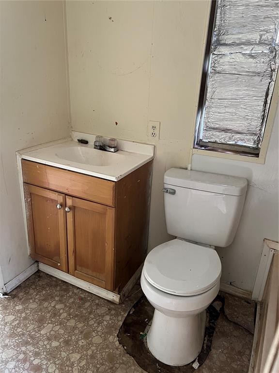 16075 Northwest 37th Terrace Reddick, FL 32686 - Photo 12 of 22 a white toilet sitting next to a bathroom sink