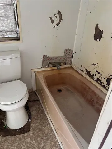 an empty room with a empty space and windows