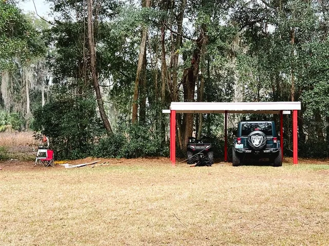 a backyard of a house with barbeque oven