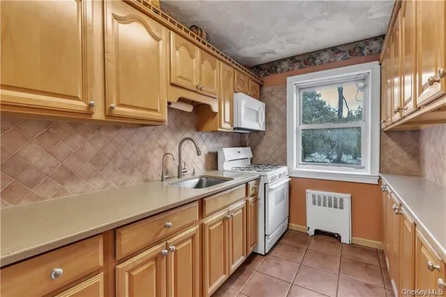 a kitchen with stainless steel appliances granite countertop a sink and a cabinets