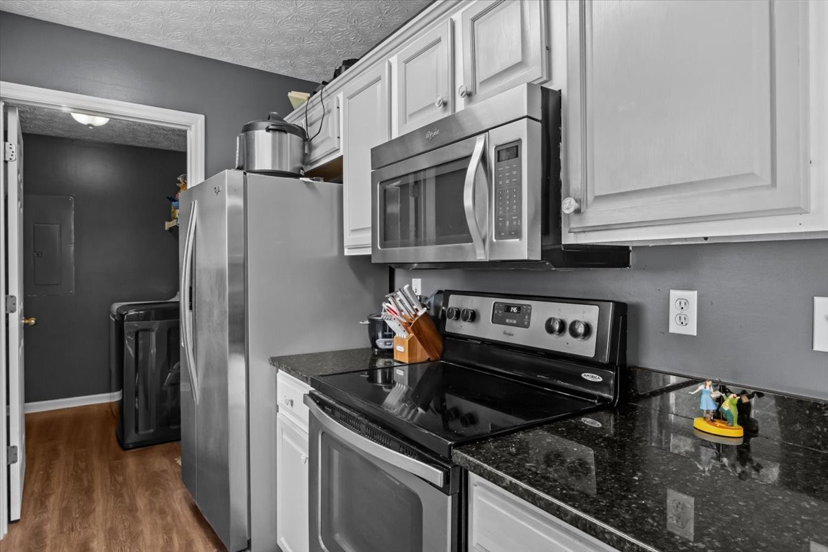 7173 New Hope Road Fairview, TN 37062 - Photo 12 of 31 a kitchen with stainless steel appliances granite countertop a refrigerator and a stove