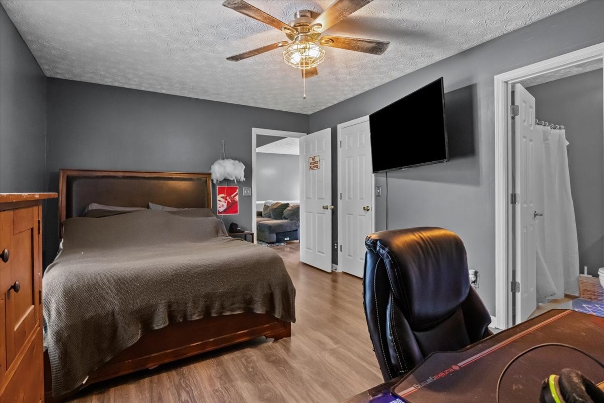 7173 New Hope Road Fairview, TN 37062 - Photo 16 of 31 a bedroom with a bed and a flat screen tv