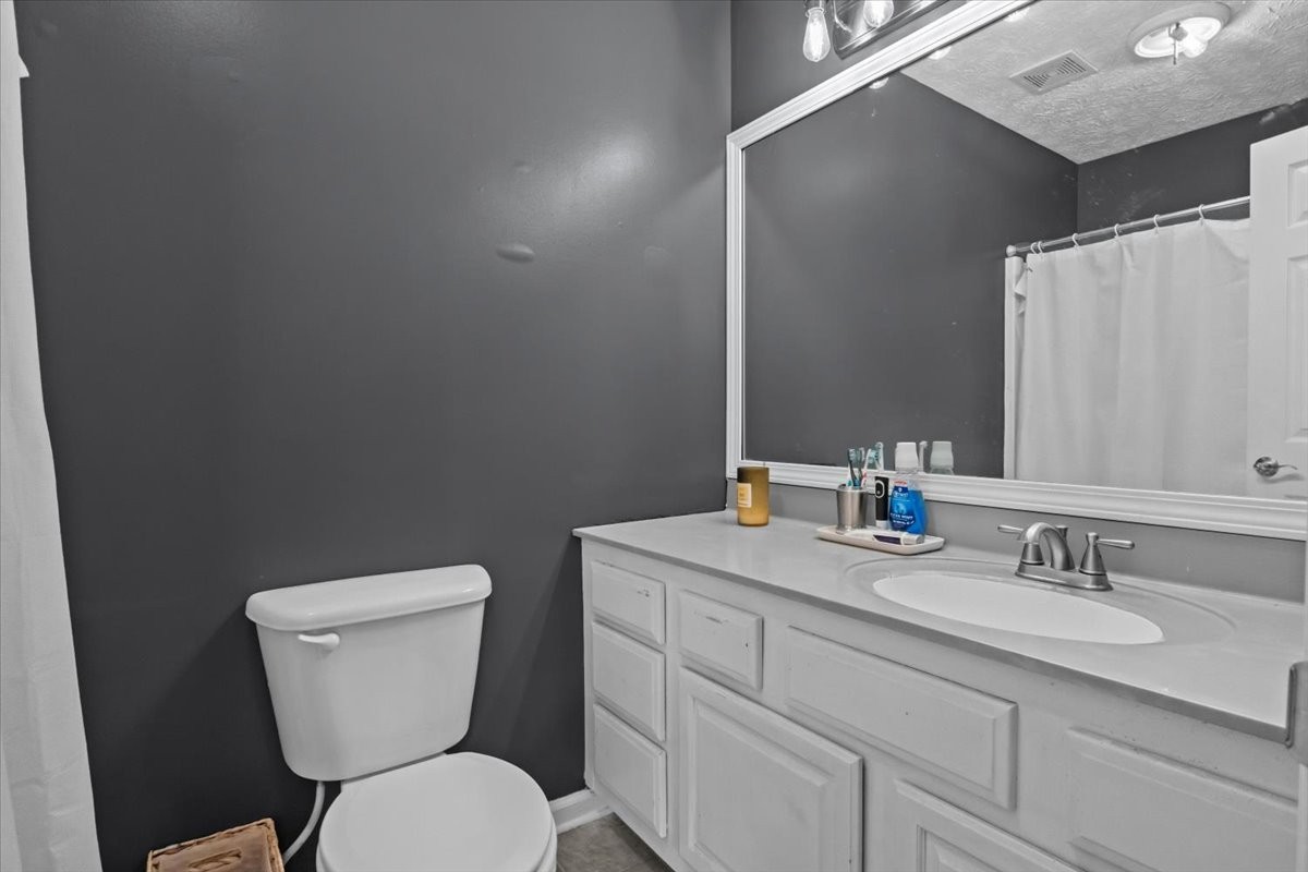 7173 New Hope Road Fairview, TN 37062 - Photo 18 of 31 a bathroom with a toilet sink and mirror