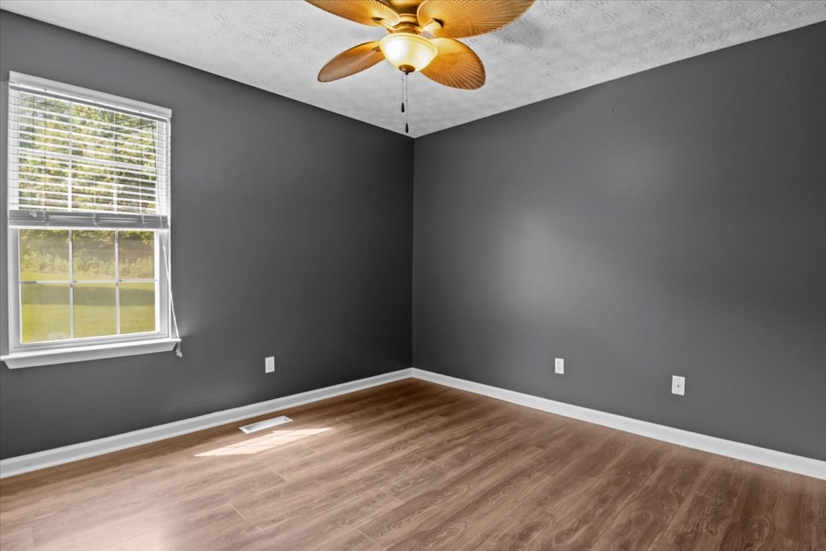 7173 New Hope Road Fairview, TN 37062 - Photo 23 of 31 an empty room with a window and a chandelier fan
