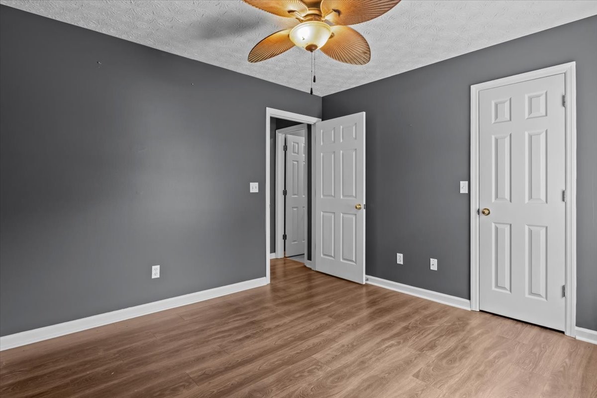 7173 New Hope Road Fairview, TN 37062 - Photo 24 of 31 an empty room with wooden floor fan and windows