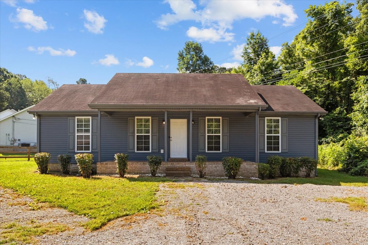 7173 New Hope Road Fairview, TN 37062 - Photo 3 of 31 a front view of a house with a yard outdoor seating and covered with trees