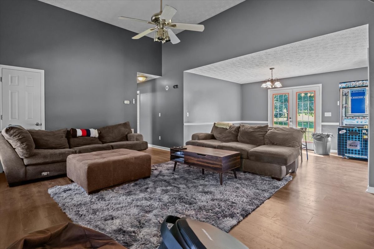 7173 New Hope Road Fairview, TN 37062 - Photo 7 of 31 a living room with furniture and a chandelier