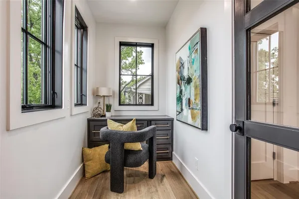 a view of kitchen and living room with wooden floor