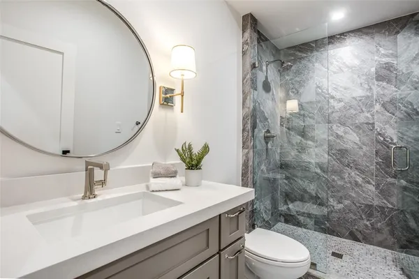 a bedroom with a large bed and a night stand