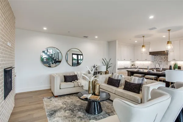 a living room with fireplace furniture and a wooden floor