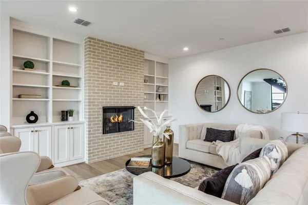 a living room with furniture a mirror and a fireplace