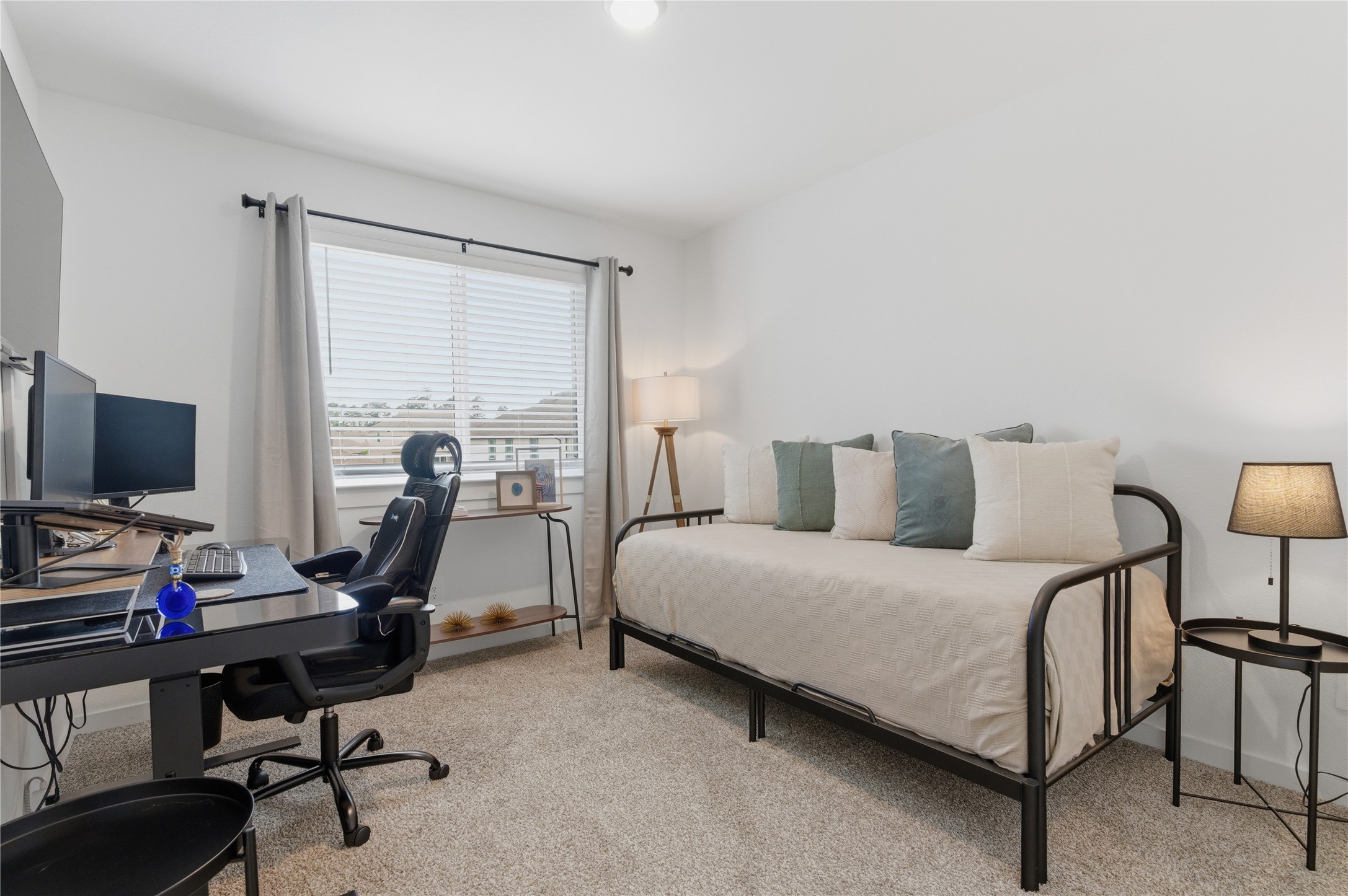 14108 Redfish Lake Conroe, TX 77384 - Photo 25 of 37 a bedroom with a bed a desk and chair
