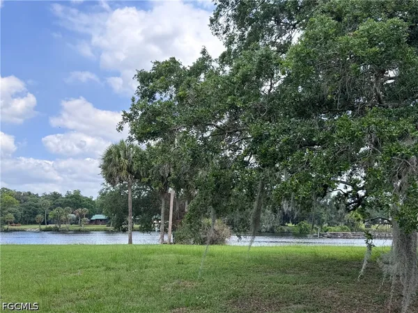a view of outdoor space with green field and trees around