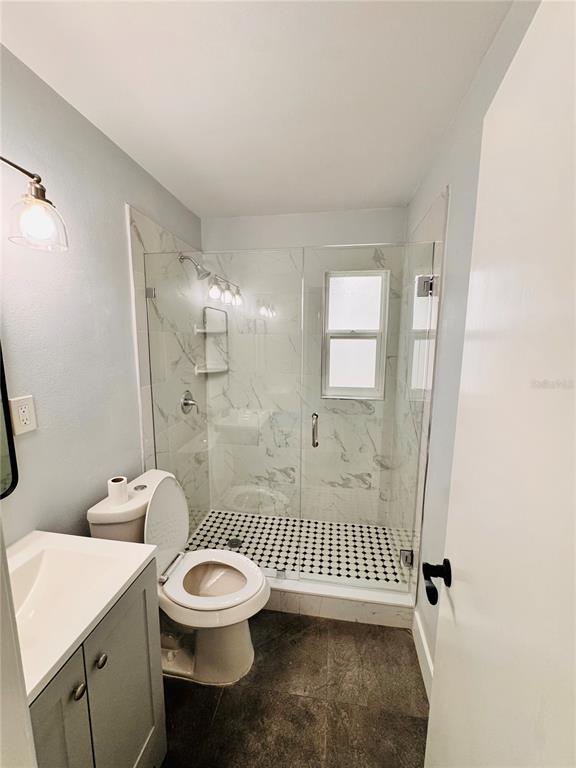 2837 18th Avenue North St. Petersburg, FL 33713 - Photo 22 of 28 a bathroom with a toilet a sink and shower