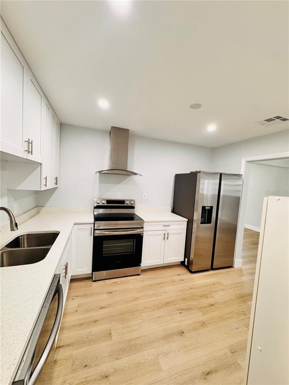 2837 18th Avenue North St. Petersburg, FL 33713 - Photo 8 of 28 a kitchen with stainless steel appliances a stove a sink and a refrigerator