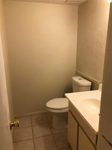 a white toilet sitting next to a white sink