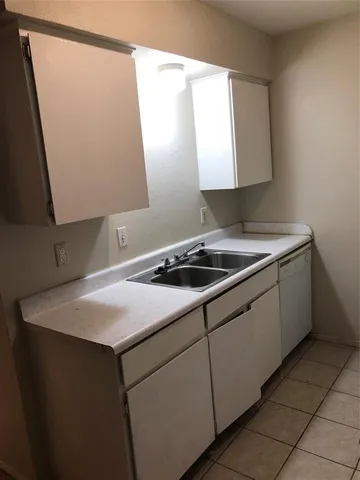 a utility room with a sink washer and dryer