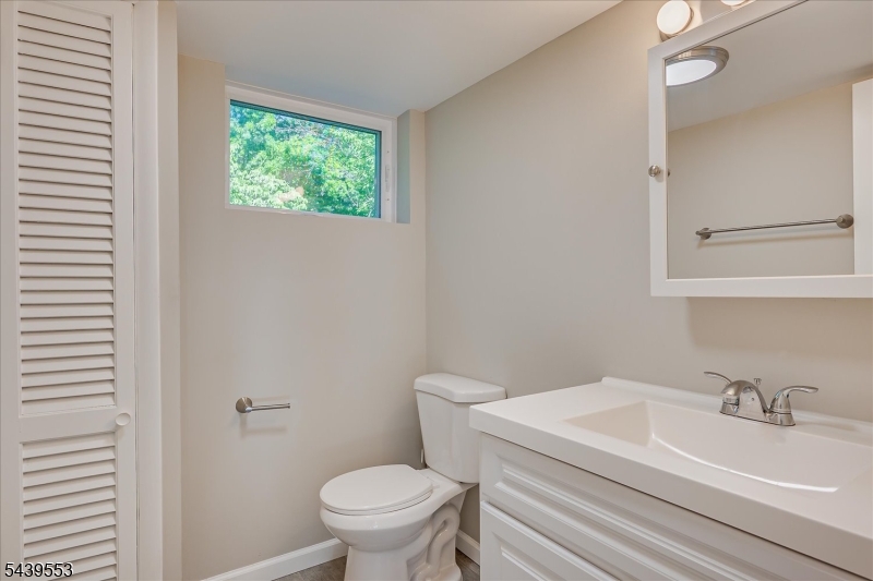 15 Woodmere Street Raritan, NJ 08869 - Photo 9 of 16 a white toilet sitting next to a bathroom sink