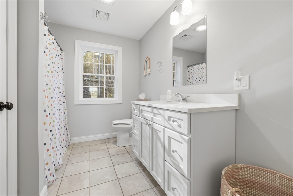 103 Rice Corner Road Brookfield, MA 01506 - Photo 30 of 39 a spacious bathroom with a sink a toilet a mirror a vanity and window