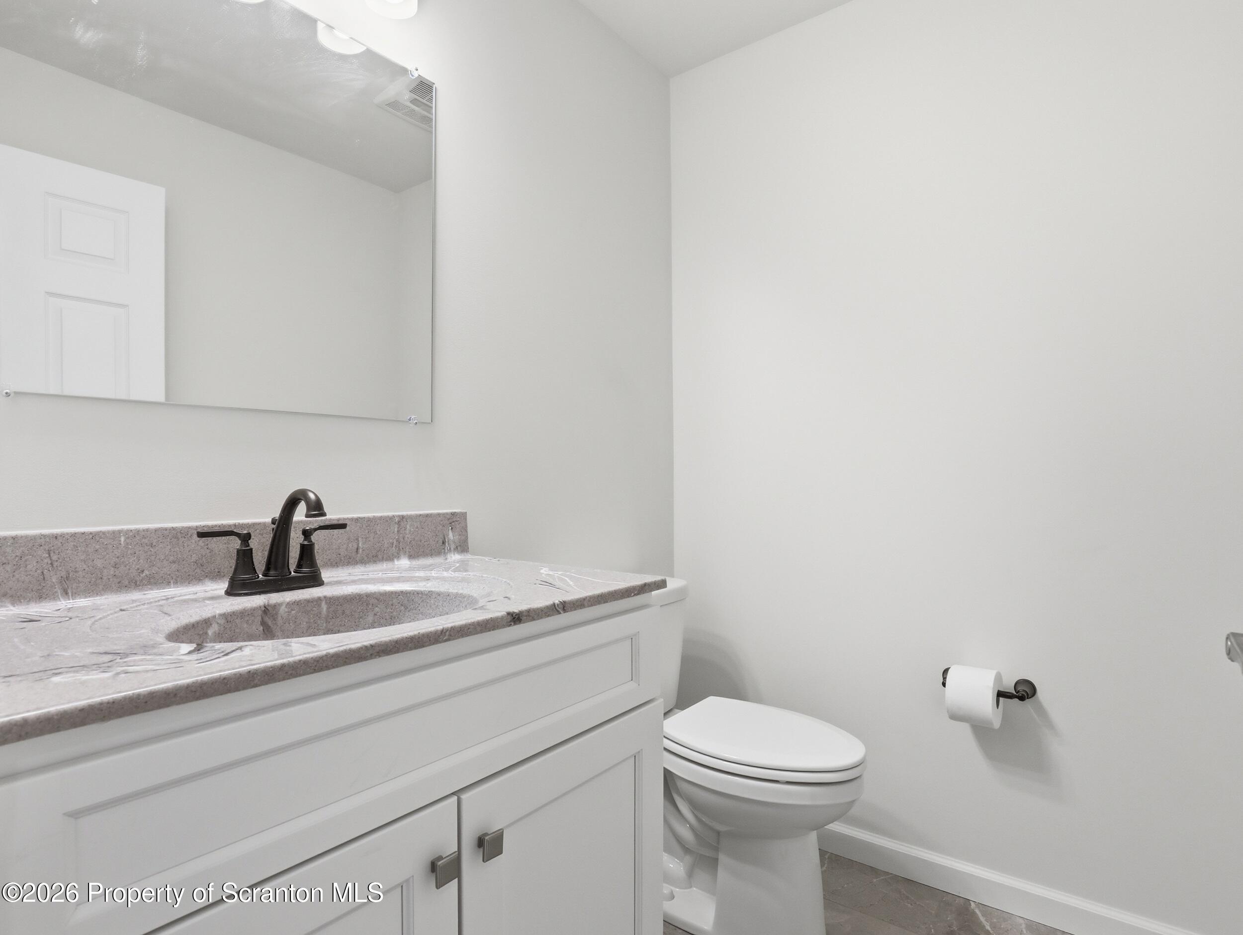 167 Braemar Terrace Tunkhannock, PA 18657 - Photo 8 of 41 a bathroom with a granite countertop toilet sink and mirror