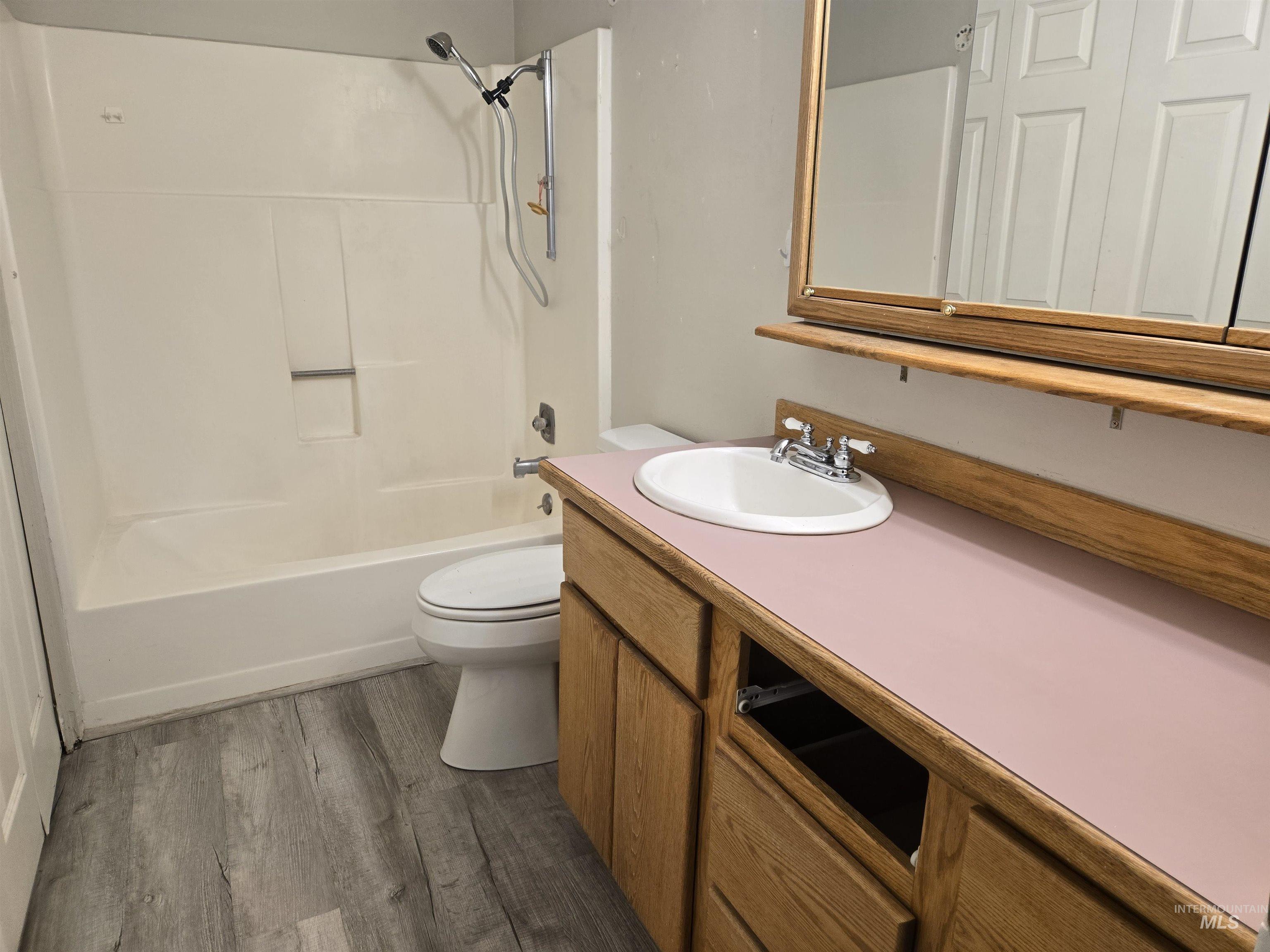 259 Pheasant Road West, Unit 50 Twin Falls, ID 83301 - Photo 20 of 23 Bathroom featuring vanity, dark wood-style floors, and shower combination
