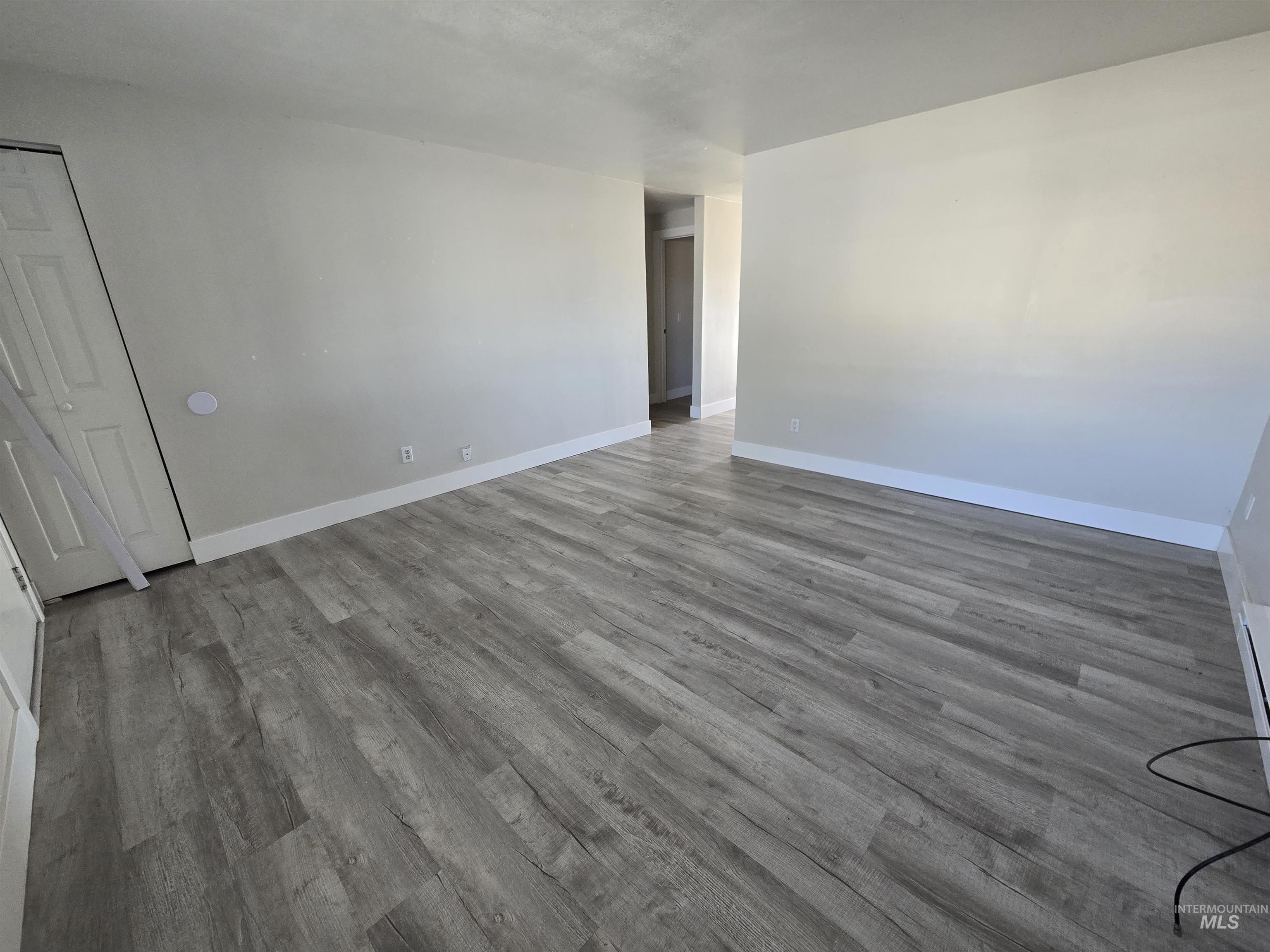 259 Pheasant Road West, Unit 50 Twin Falls, ID 83301 - Photo 8 of 23 Empty room featuring wood finished floors and baseboards