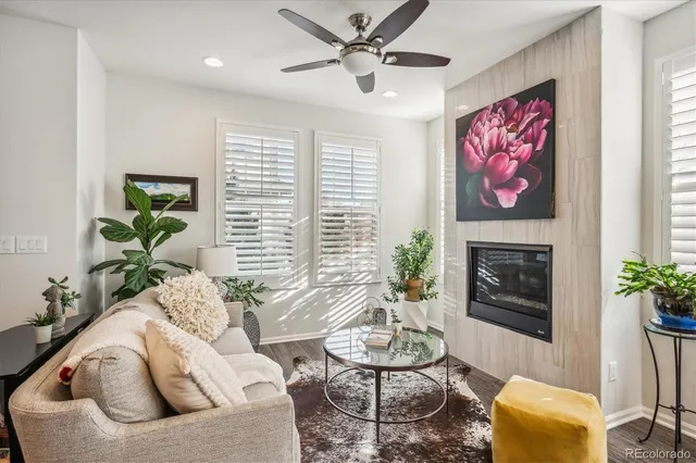 a living room with furniture flower pot and a fireplace