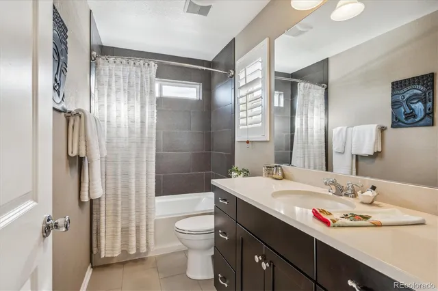 a bathroom with a sink toilet double vanity and shower