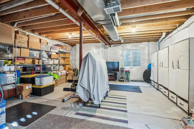 a room with lots of white furniture and a window