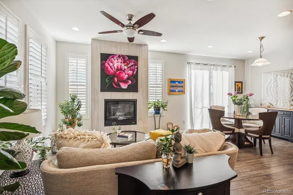 a living room with fireplace furniture and a large window