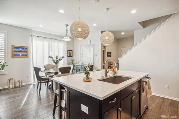 a view of a dining room with furniture wooden floor and chandelier