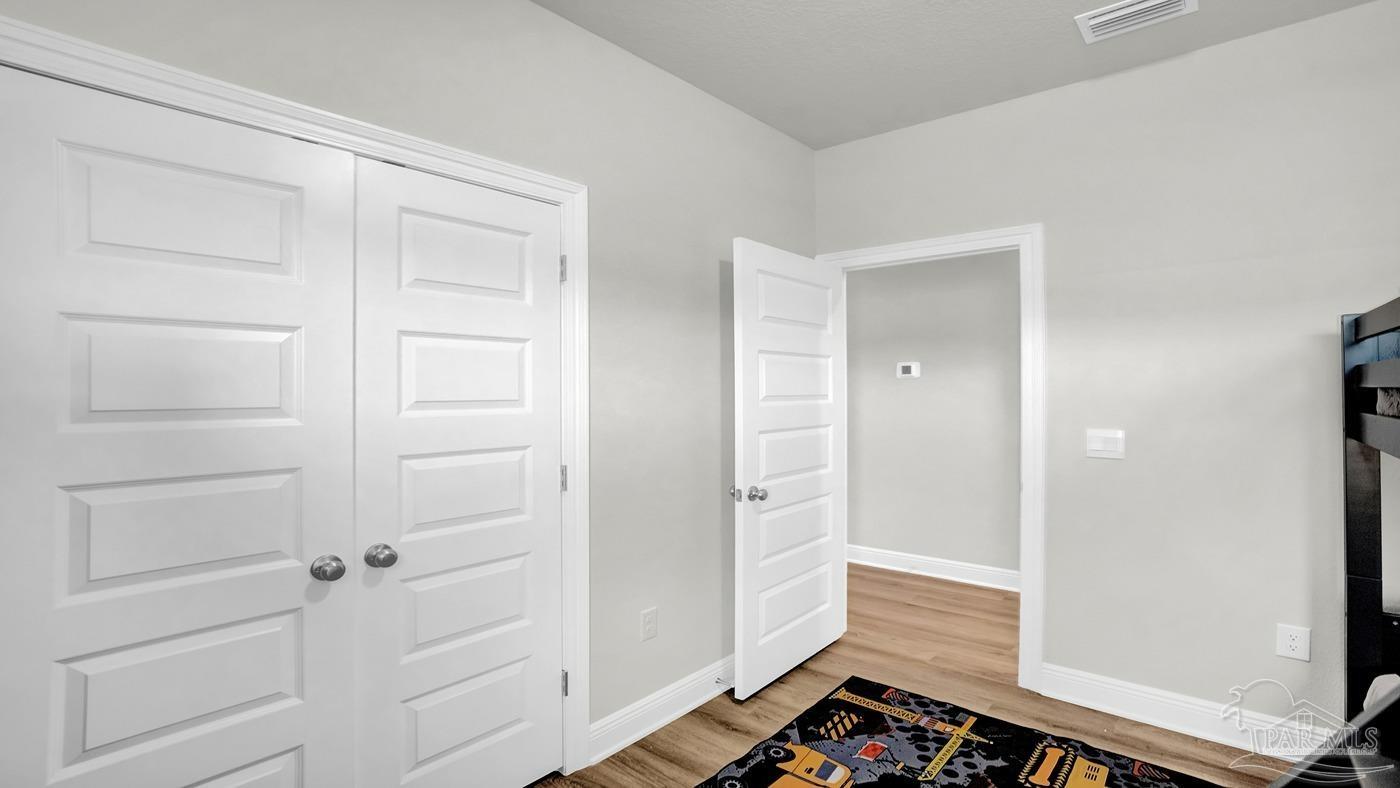24 Spoonbill Street Cantonment, FL 32533 - Photo 12 of 30 wooden floor in an empty room