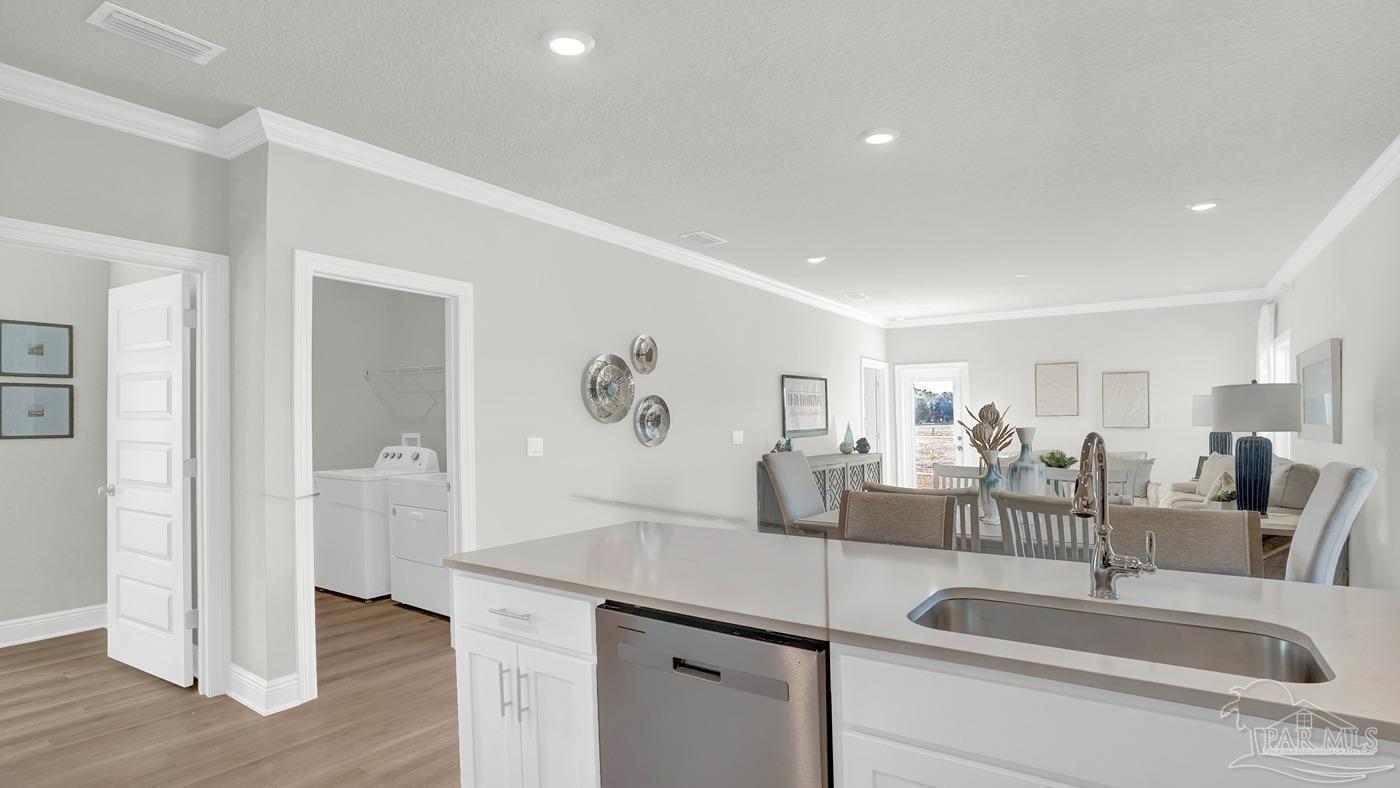 24 Spoonbill Street Cantonment, FL 32533 - Photo 20 of 30 a kitchen with a sink and a refrigerator