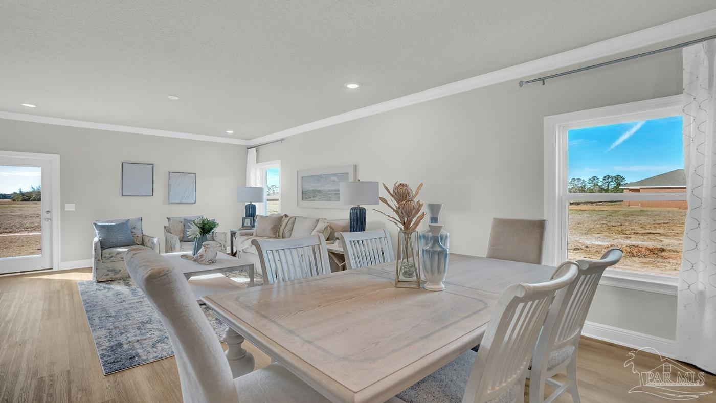 24 Spoonbill Street Cantonment, FL 32533 - Photo 21 of 30 a view of a dining room with furniture window and wooden floor