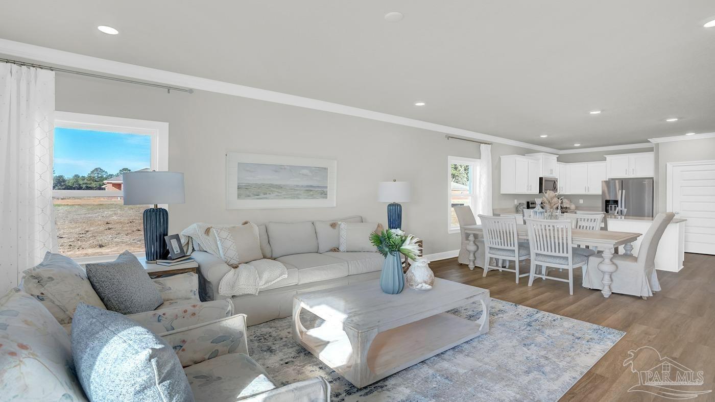 24 Spoonbill Street Cantonment, FL 32533 - Photo 24 of 30 a living room with furniture potted plant and view of kitchen