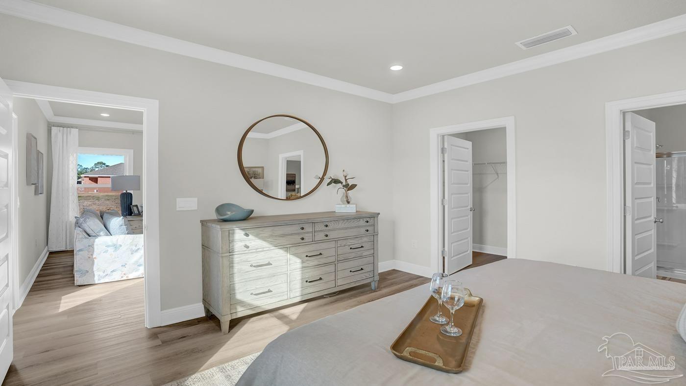 24 Spoonbill Street Cantonment, FL 32533 - Photo 27 of 30 a room with a bed and a dresser