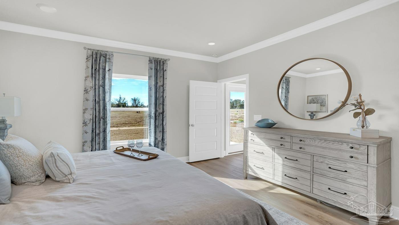 24 Spoonbill Street Cantonment, FL 32533 - Photo 28 of 30 a bedroom with a large bed and a dresser