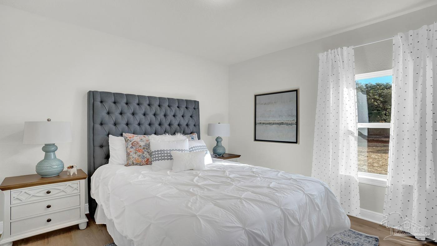 24 Spoonbill Street Cantonment, FL 32533 - Photo 6 of 30 a bedroom with a bed and a window