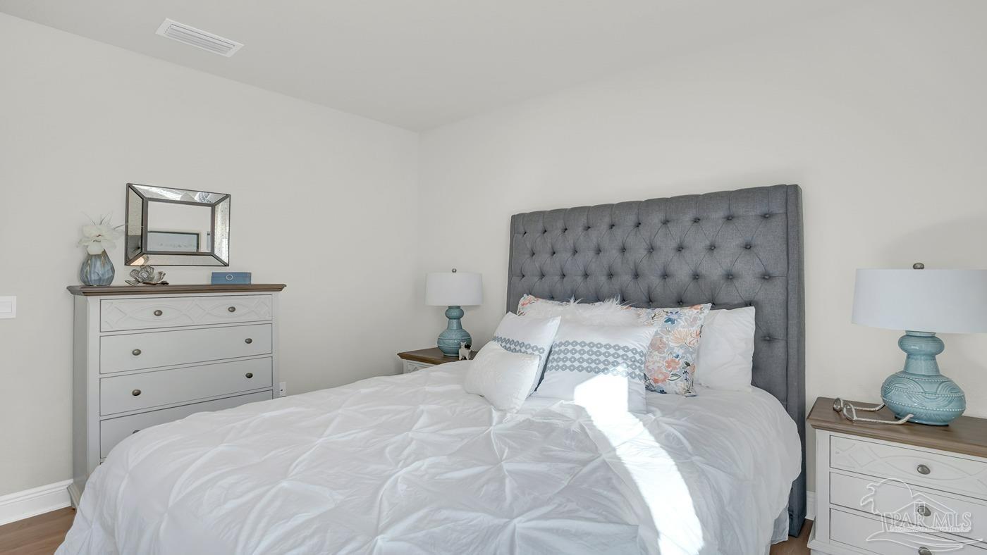 24 Spoonbill Street Cantonment, FL 32533 - Photo 7 of 30 a bedroom with a bed and a dresser