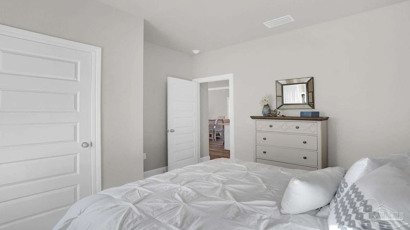 24 Spoonbill Street Cantonment, FL 32533 - Photo 8 of 30 a bedroom with a bed and a dresser