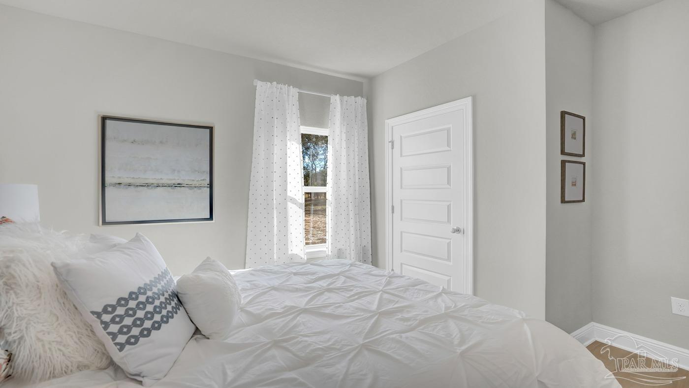 24 Spoonbill Street Cantonment, FL 32533 - Photo 9 of 30 a bedroom with a bed and a window