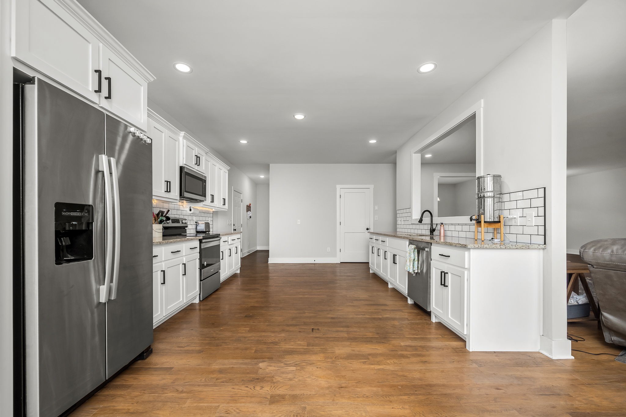 3880 Short Mountain Road Woodbury, TN 37190 - Photo 15 of 59 a large kitchen with stainless steel appliances a refrigerator and a stove top oven