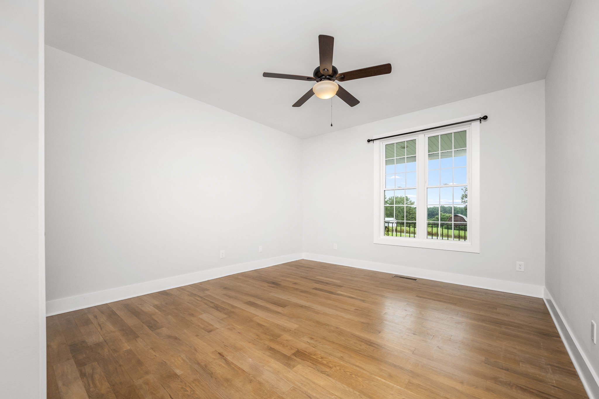 3880 Short Mountain Road Woodbury, TN 37190 - Photo 29 of 59 a view of a big room with wooden floor and windows in a room