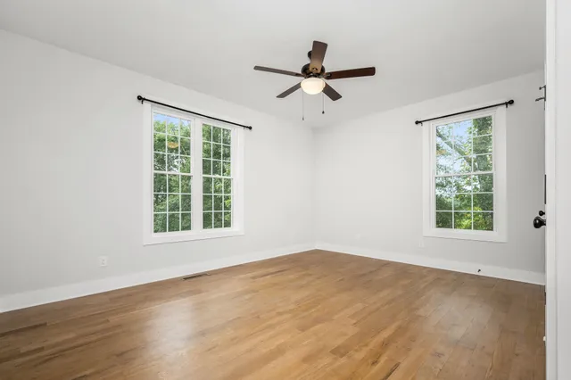 a view of a livingroom with a ceiling fan and window