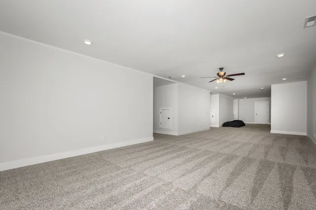 a bathroom with a granite countertop sink a toilet and a shower